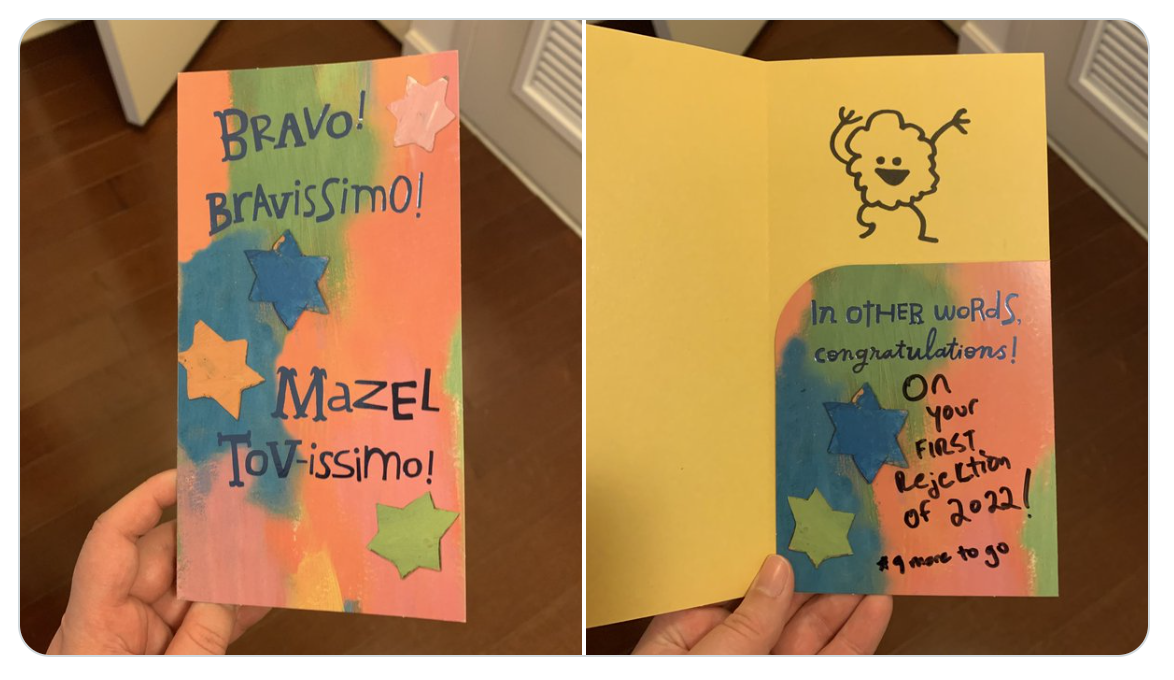 A greeting card that says "Bravo! Bravissimo! Mazel Tov-issimo!" on the outside. Inside, someone has written in black marker "Congratulations on your first rejection of 2022! 9 more to go"