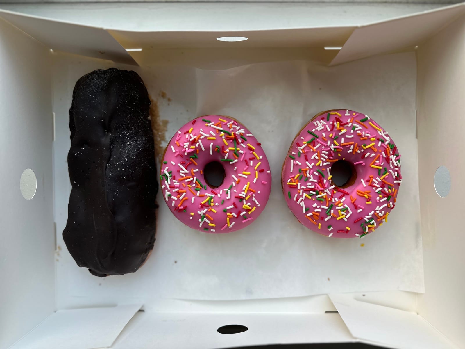 Three donuts from Randy's Donuts that spell out 100